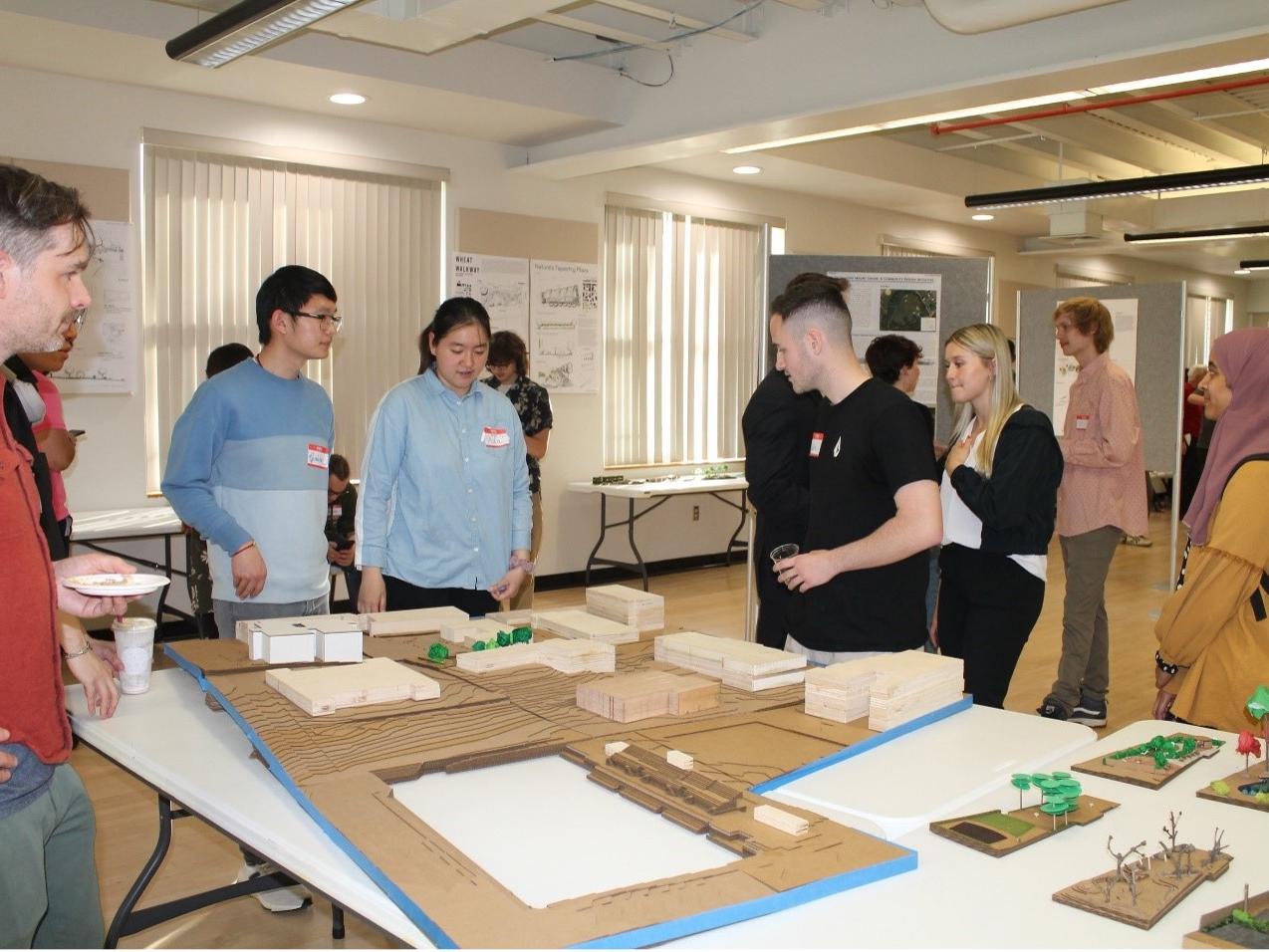 Assistant Professor Alec Spangler (left) with the context model built by students. 