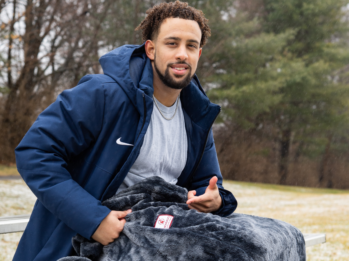 Penn State Nittany Lions Defensive Back and 2023 Rose Bowl Champion Keaton Ellis poses with the Koveroo blanket