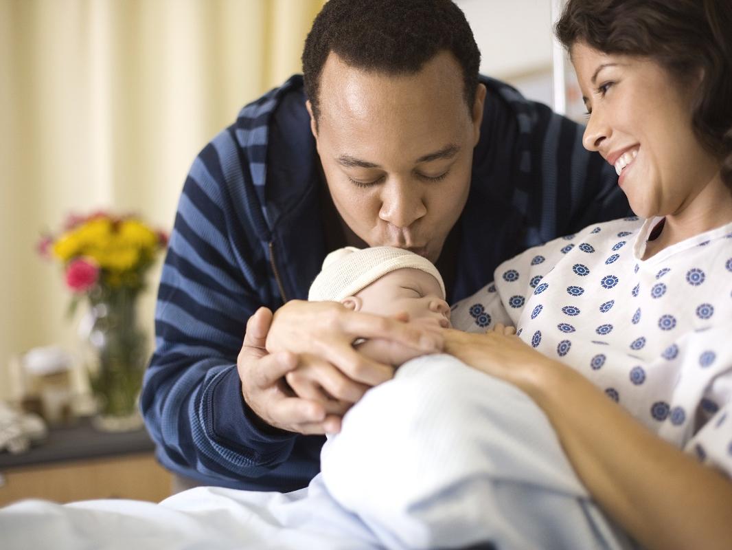 Mother and father with newborn infant.