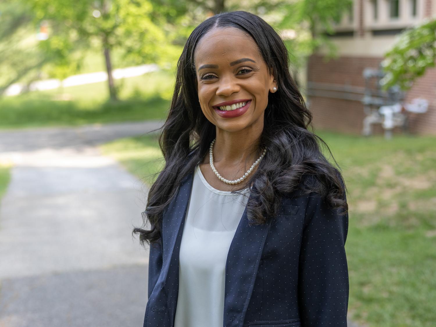 A woman stands outside a building.