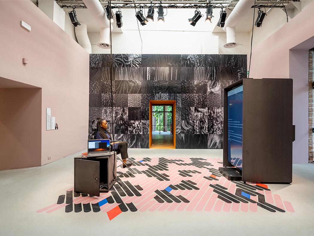 Felecia Davis sits in a hair salon chair in her display at the Venice Biennale. 