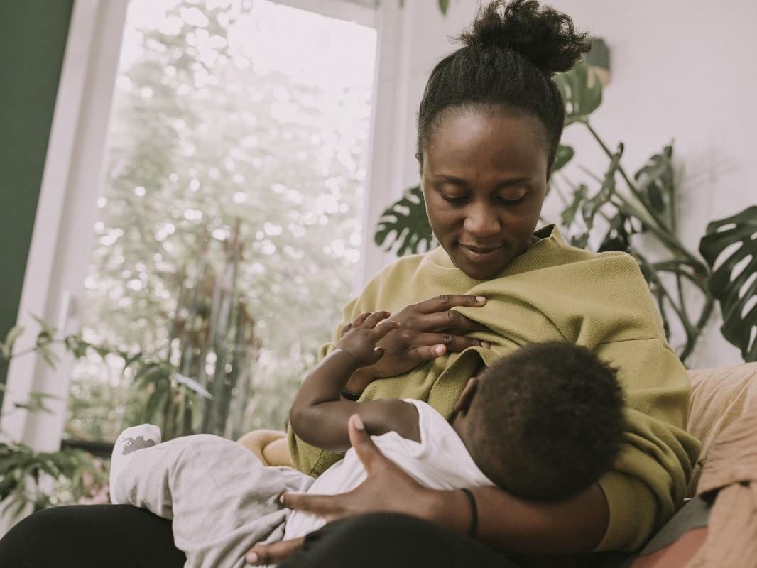 A mother breast feeds her baby.