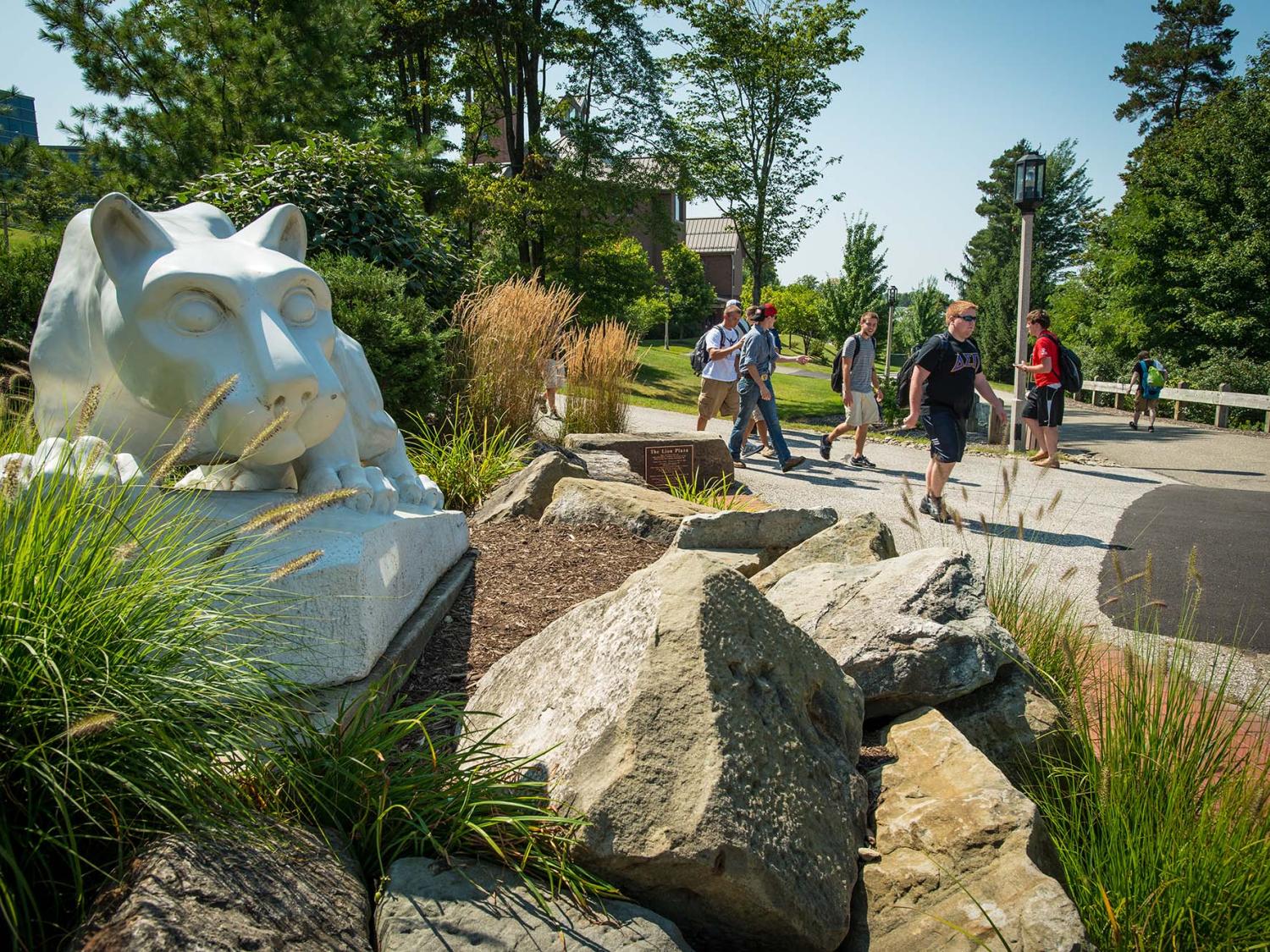 Students walk near the Nittany Lion shrine at Penn State Behrend