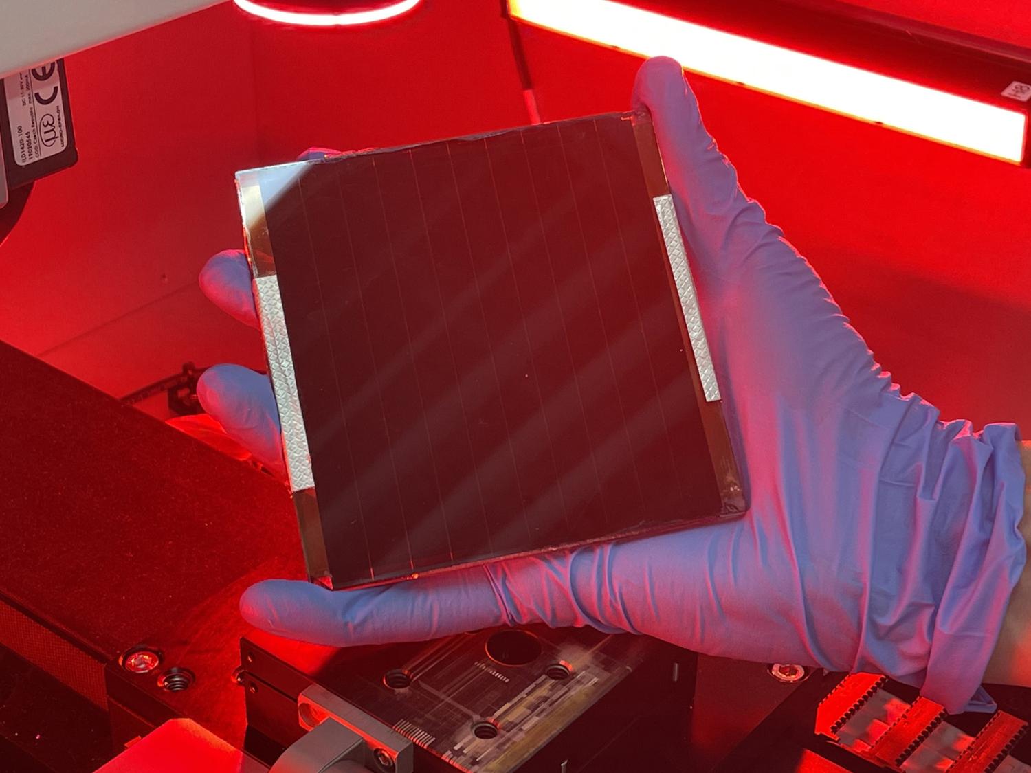 A researcher holds a bio-inspired solar device 