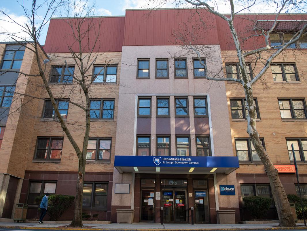 An exterior shot of the Penn State Health St. Joseph Downtown Campus, a building with brick and windows, and an awning with the Penn State Health St. Joseph logo.