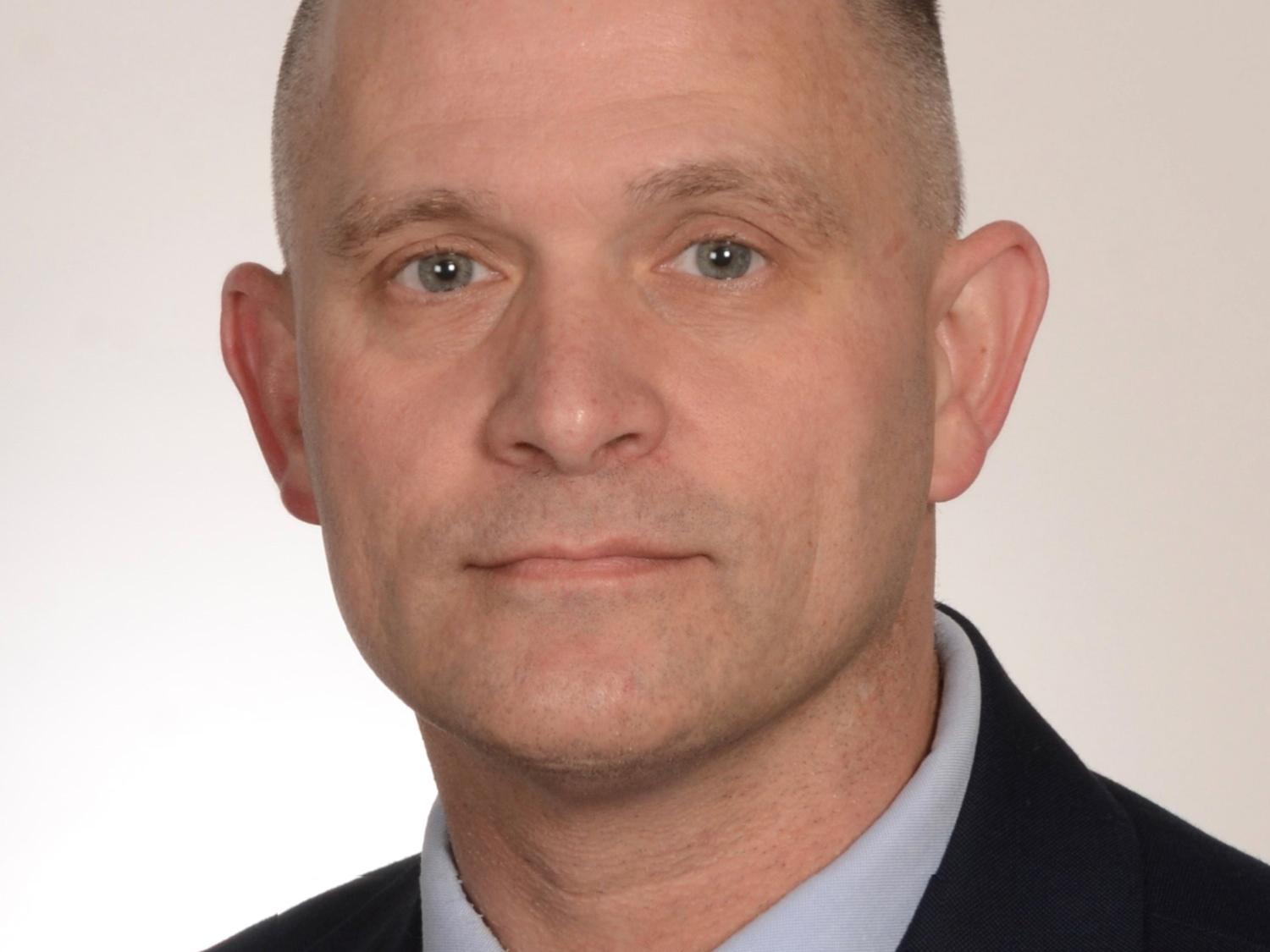 Headshot of person in a suit