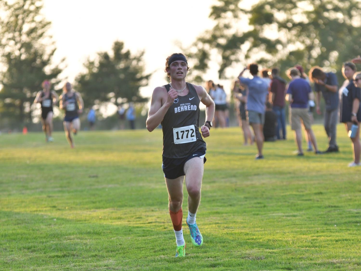 A Penn State Behrend runner competes in a cross country race.