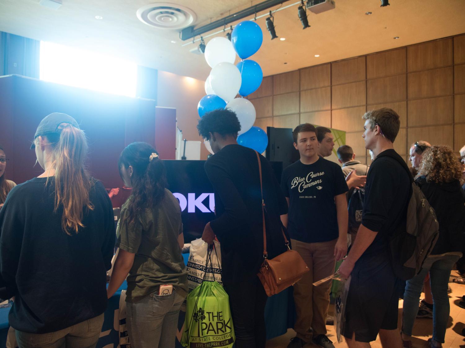 Student and families connecting with housing representatives during the housing fair on campus