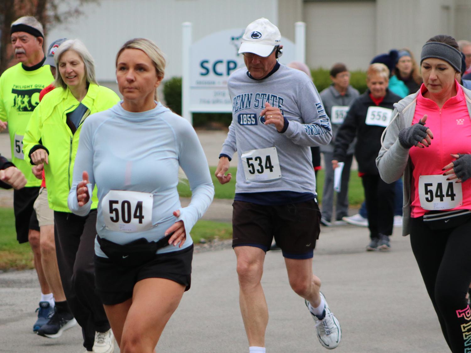Runners and walkers outdoors wearing bib numbers at the Jane Williams 5k