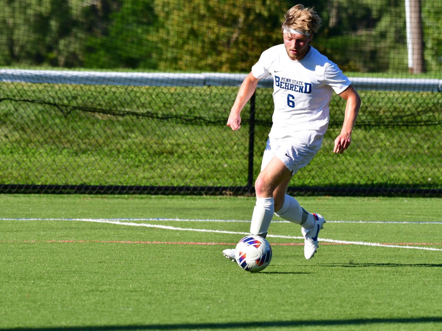 Penn State Behrend soccer player Jonathan Swann prepares to kick the ball.