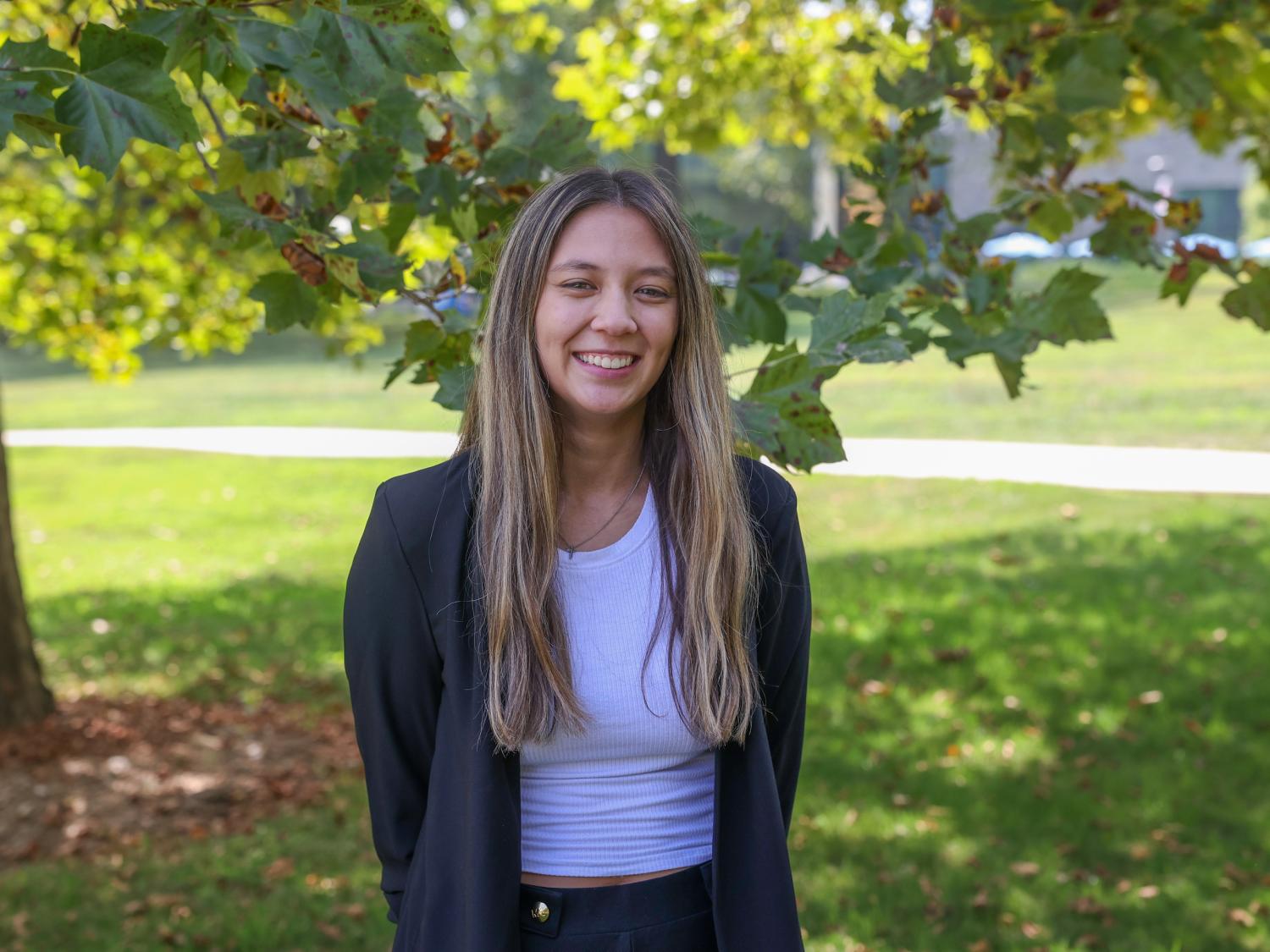 Madison Ollis standing in front of tree