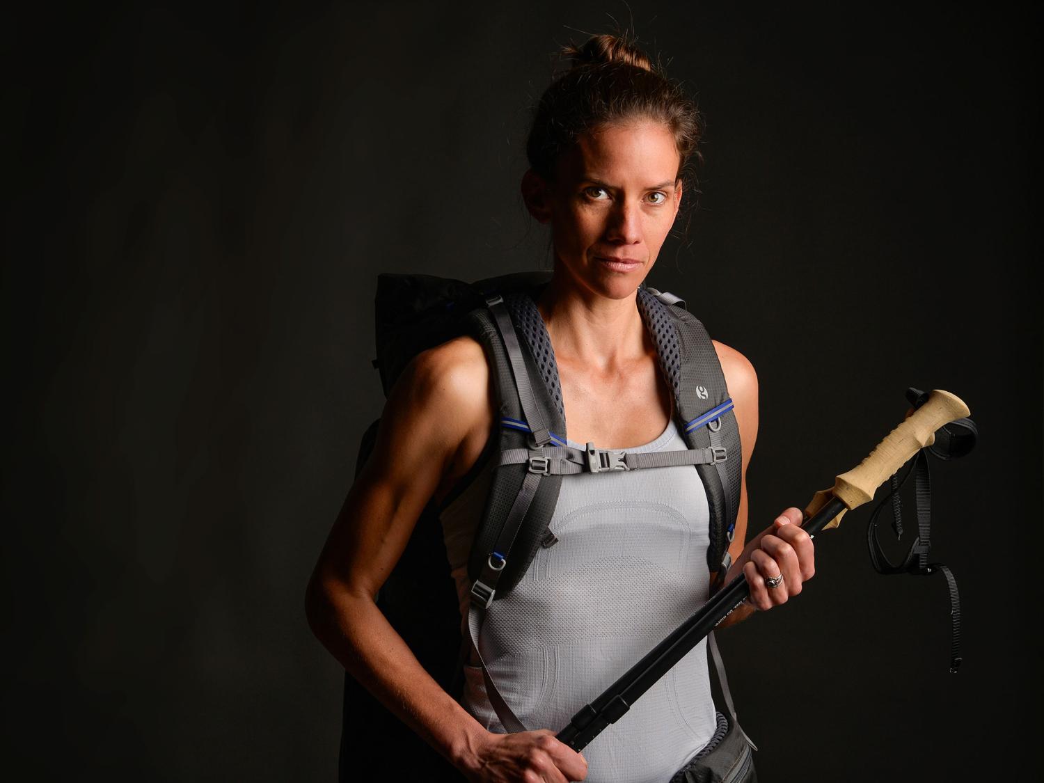 Jennifer Pharr Davis holding a hiking stick and wearing a backpack