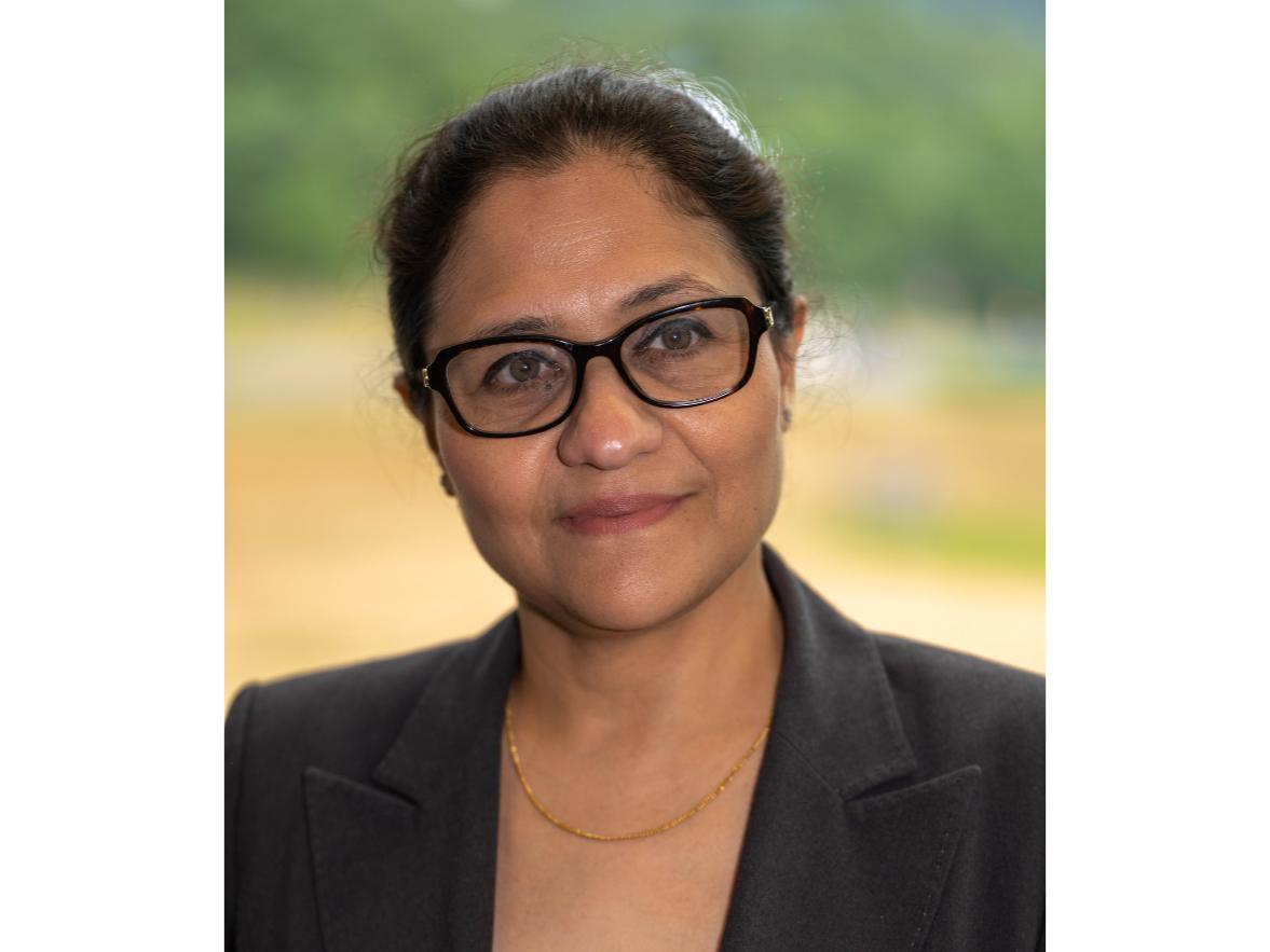 Portrait of a person wearing glasses and a blazer