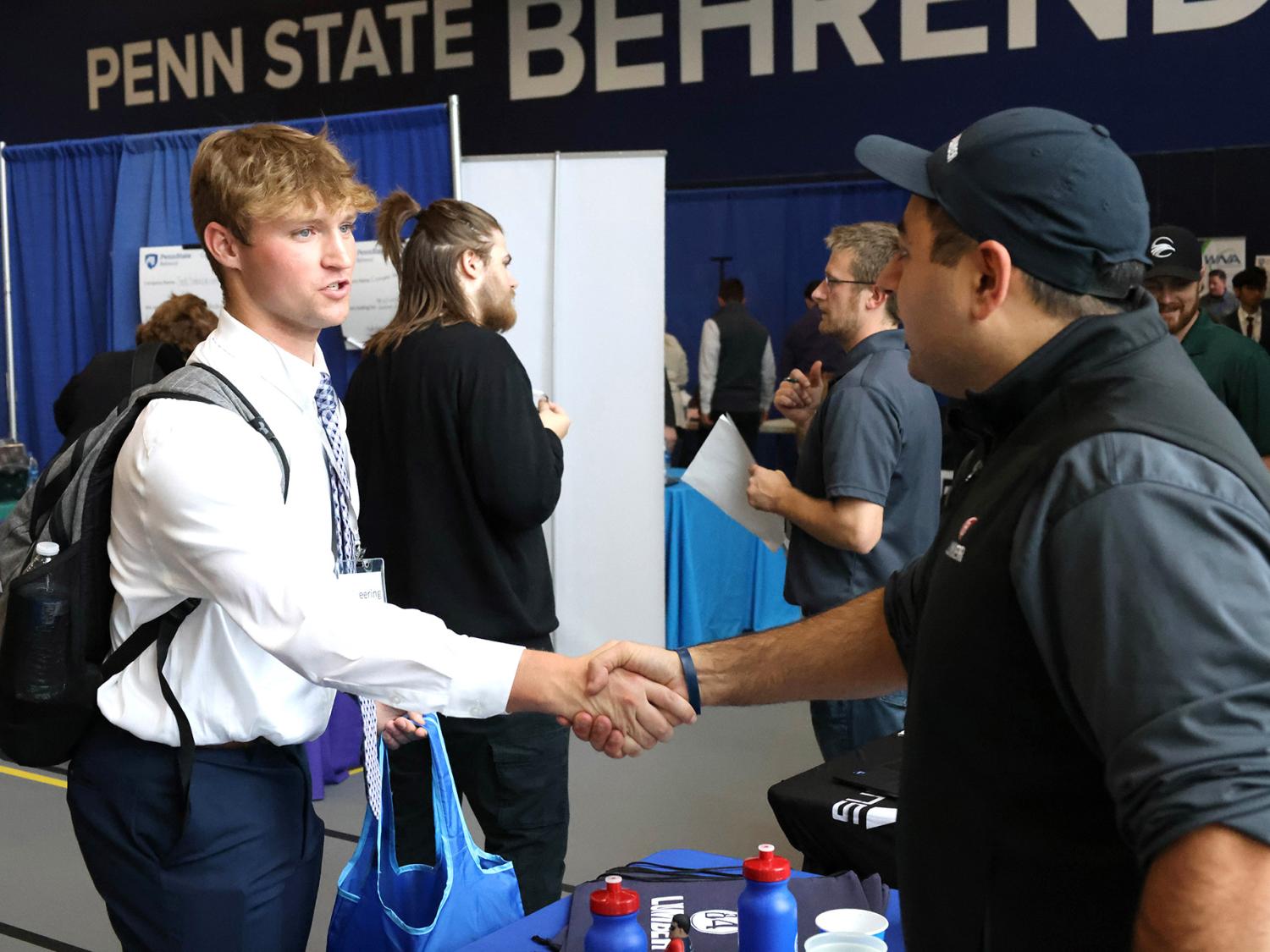 A Penn State Behrend student shakes a recruiter's hand during a career fair.