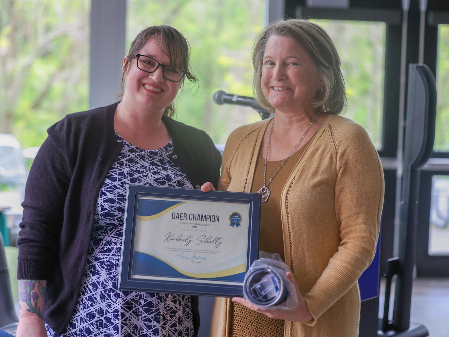 two women holding certificate
