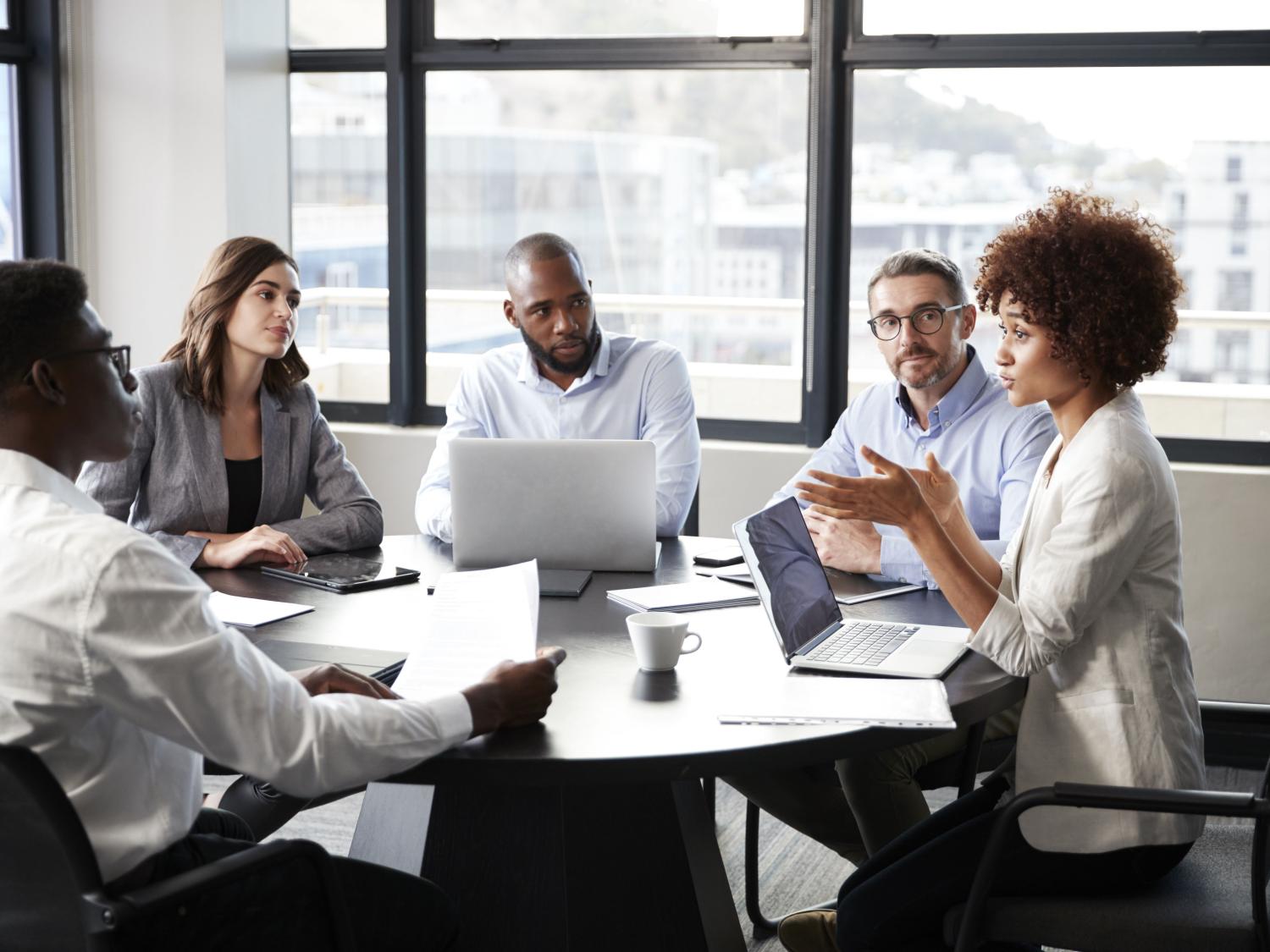 five people at business meeting