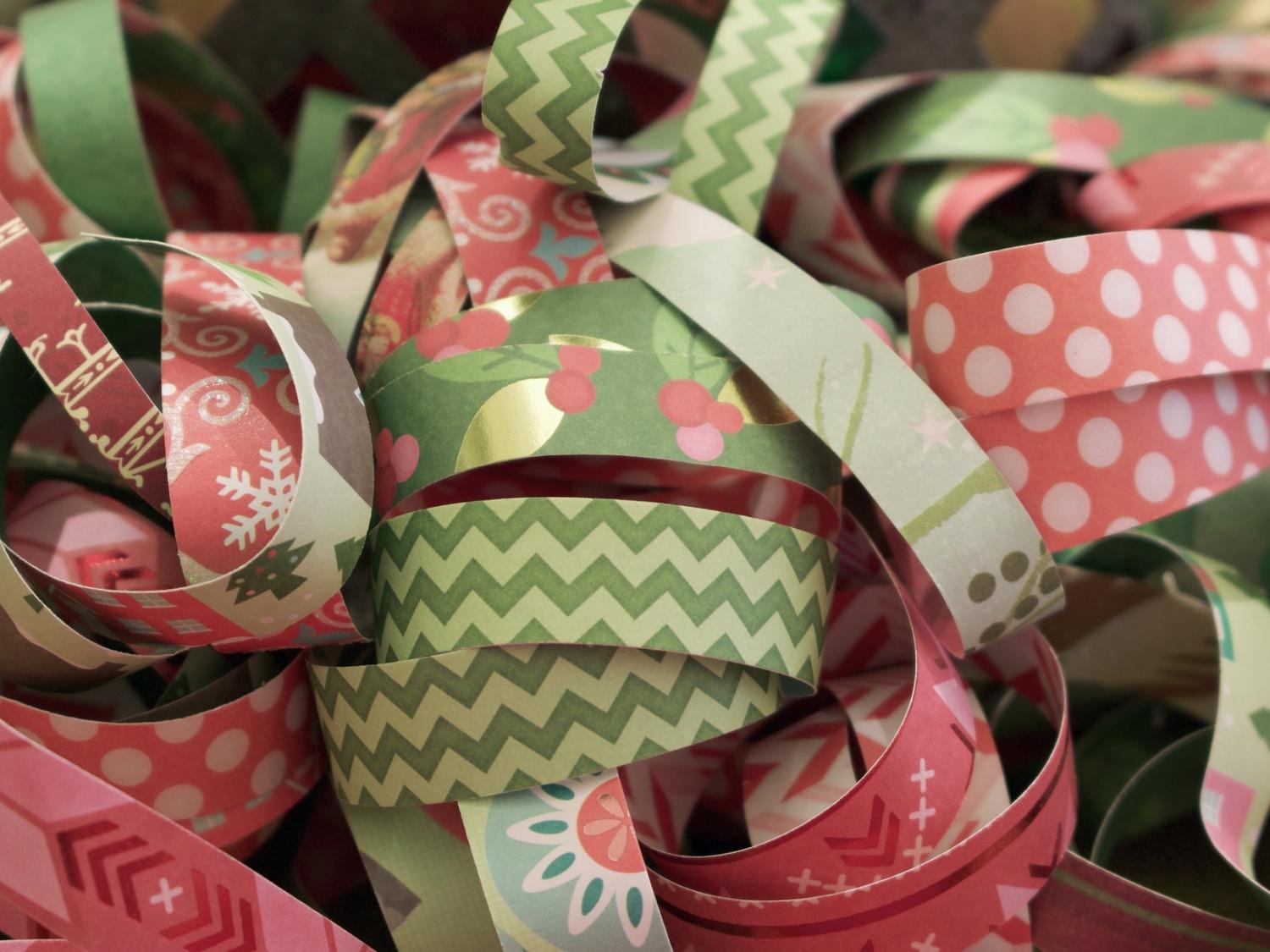 A close-up image of rolls of pink and green ribbon