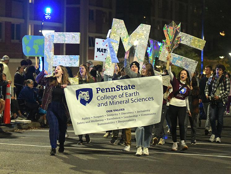 Students from the College of Earth and Mineral Sciences cheer at the parade