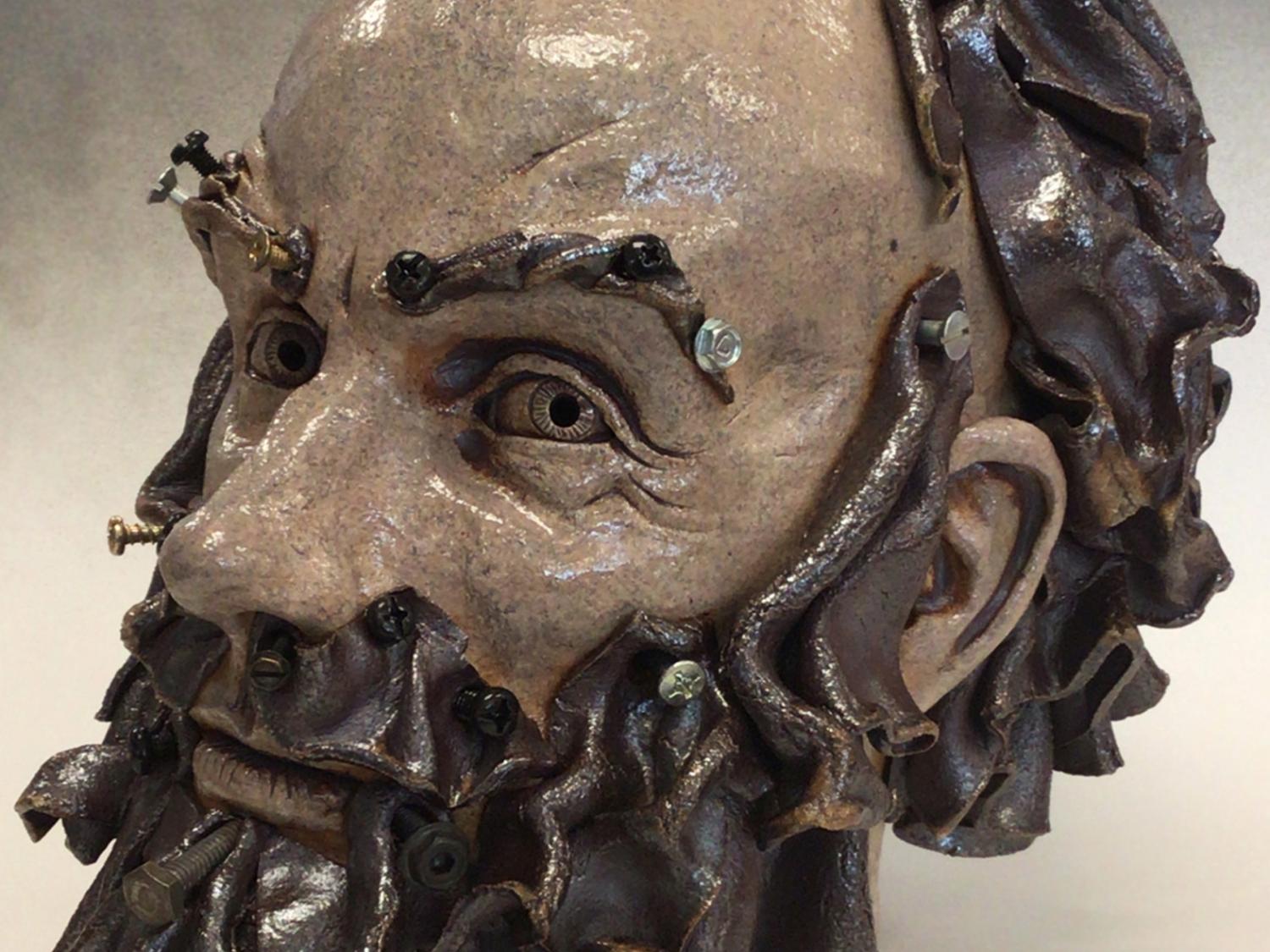 A stoneware sculpture of a bearded head by Gerald Kaplan