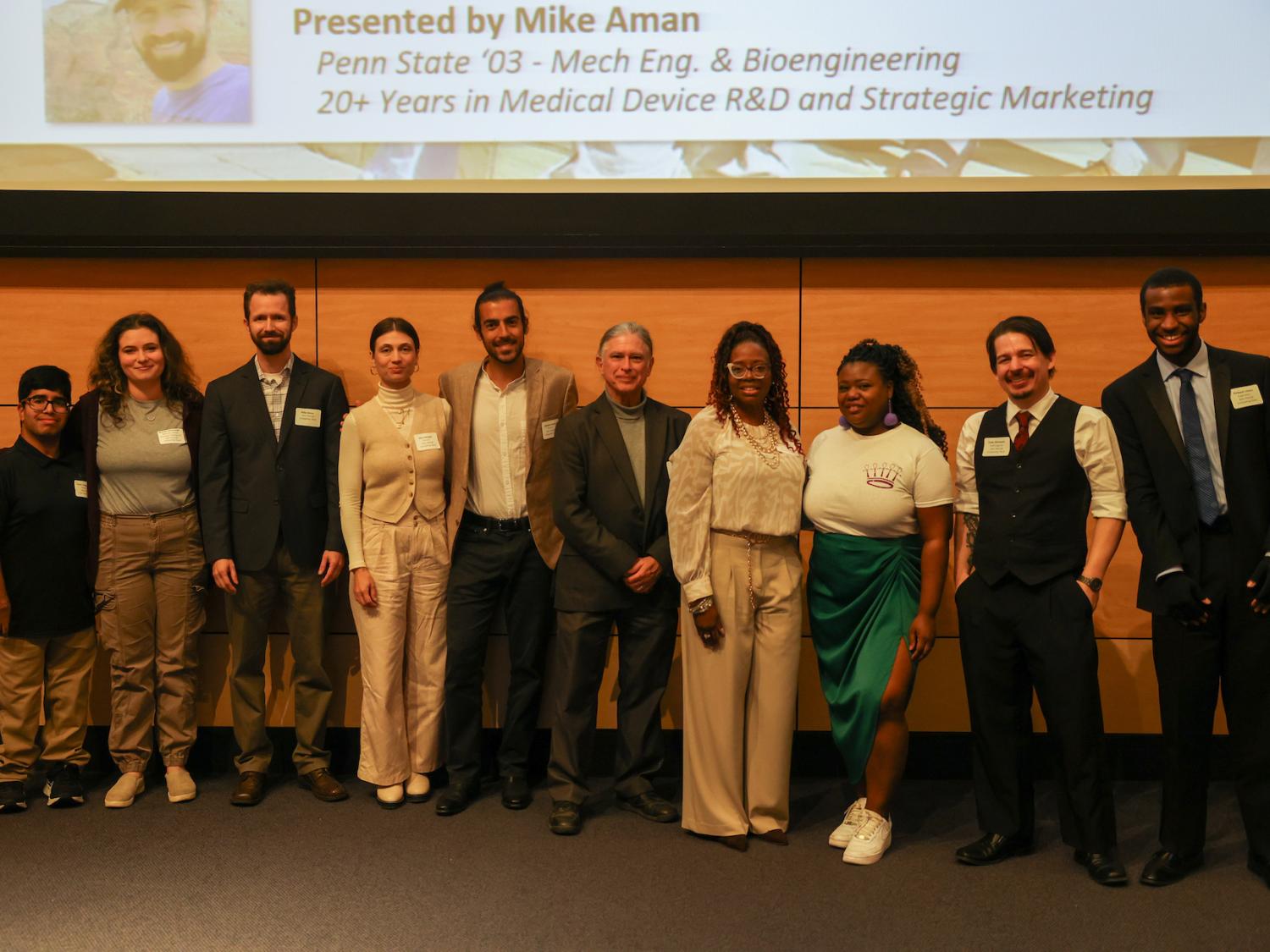 nine startup business owners smiling after pitch competition