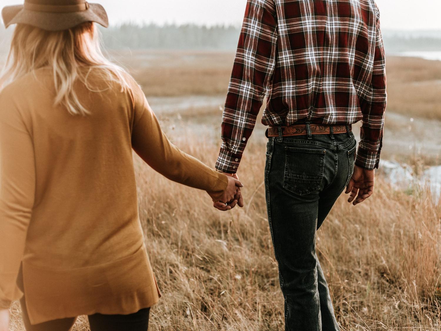 farm couple holding hands 