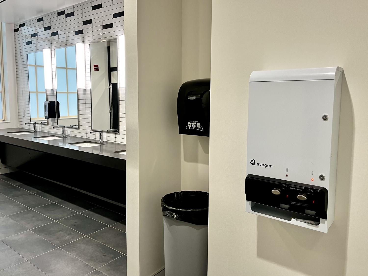 Campus restroom featuring new menstrual product dispenser.