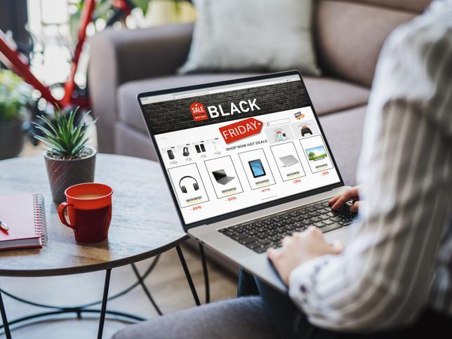 A person using a laptop to shop online Black Friday deals
