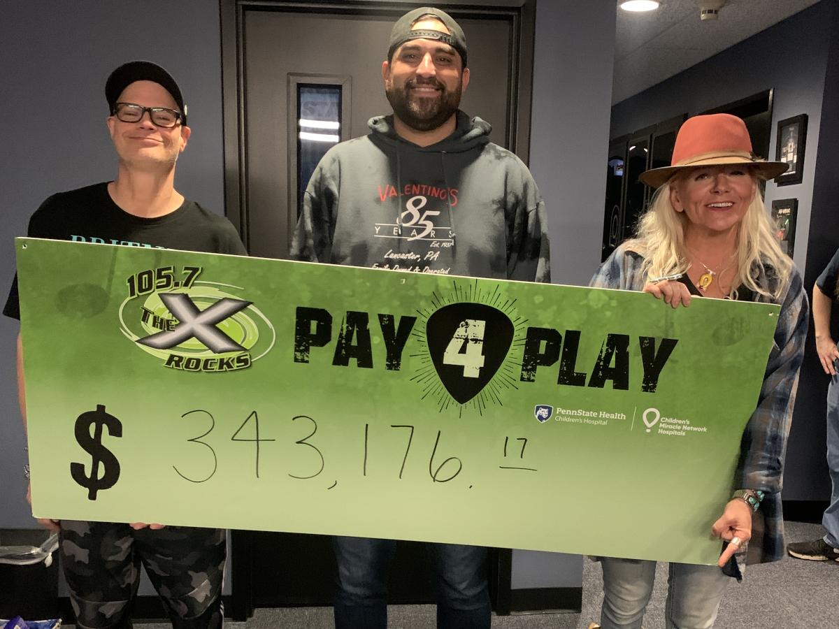 Three people smile as they pose with an oversized check in the amount of $343,176.17.