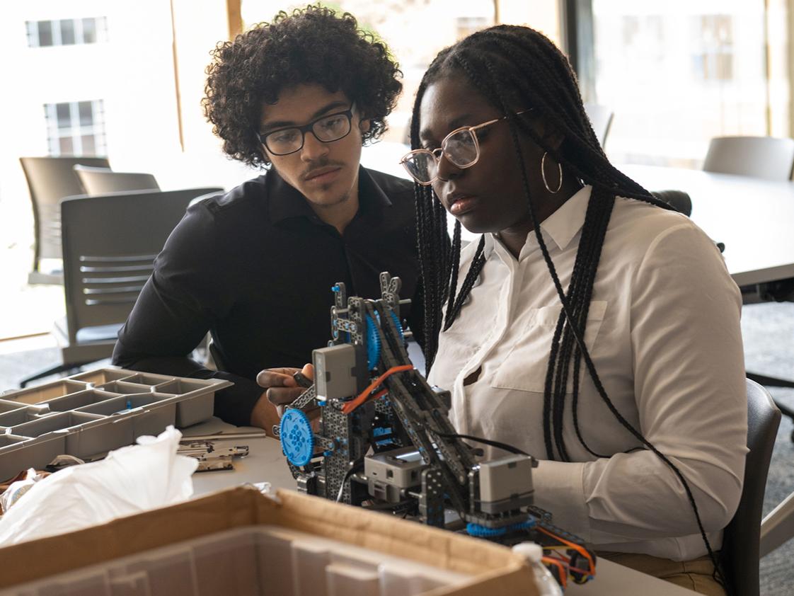 Two students work on an engineering project.