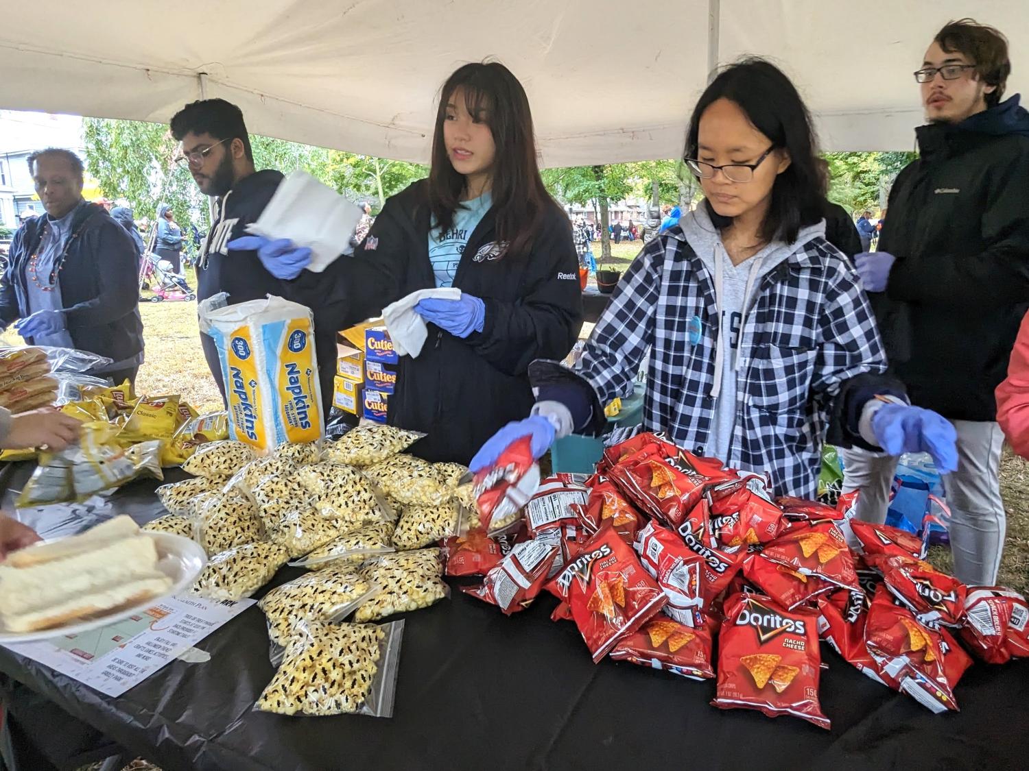 Penn State Behrend students serve food at the Our West Bayfront festival in Erie.