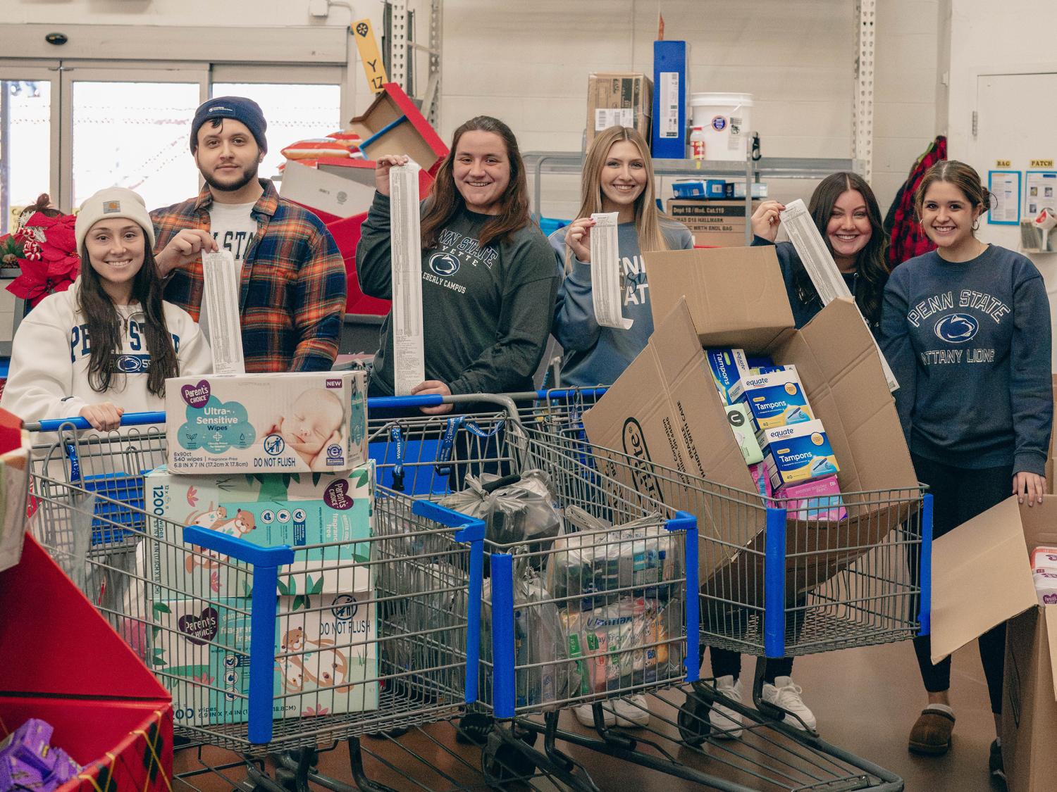 Penn State Fayette students participate in a charity drive, showcasing donated items for community support.