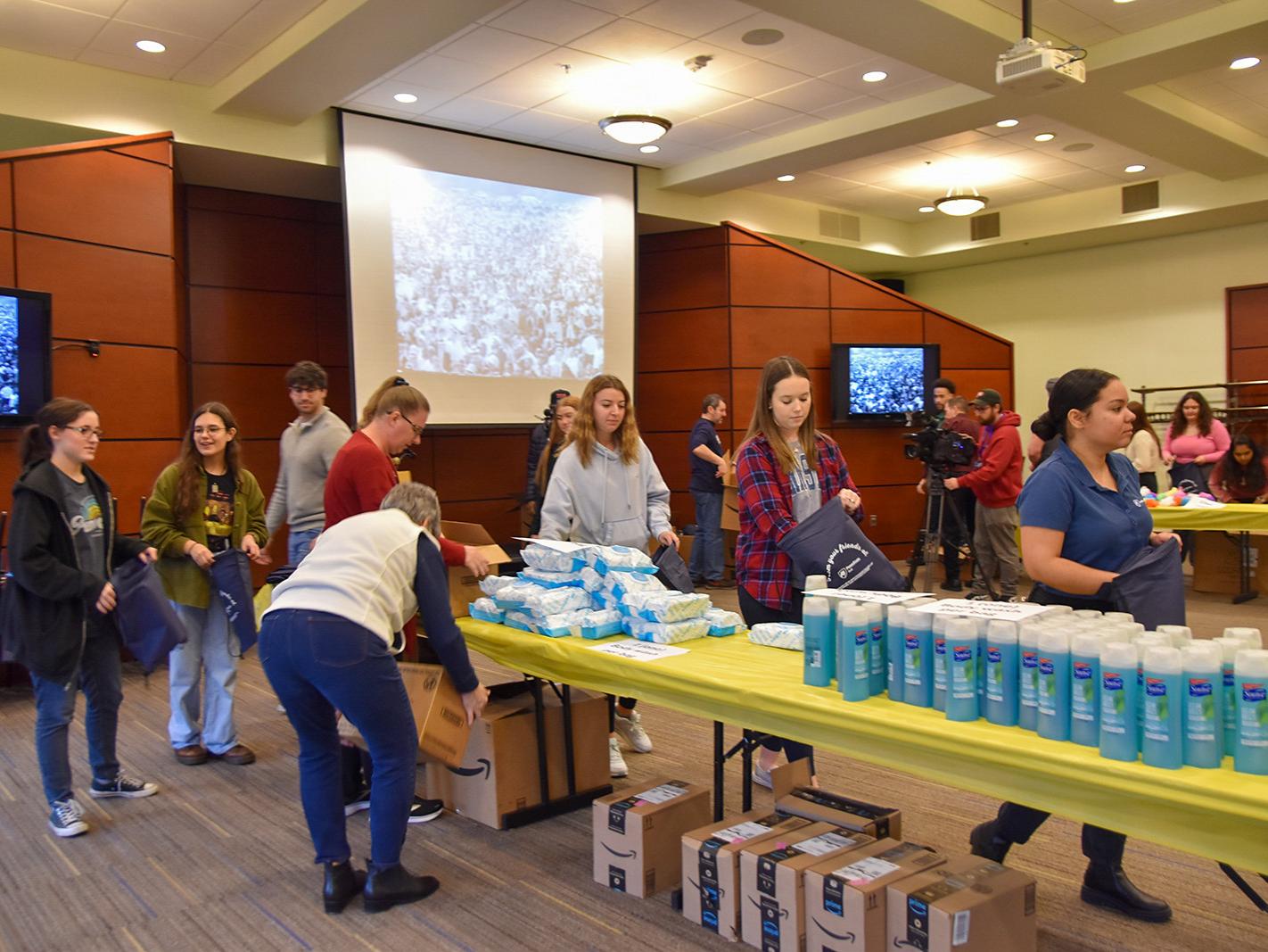Students, faculty, and staff assembling hygiene kits for the YWCA of York