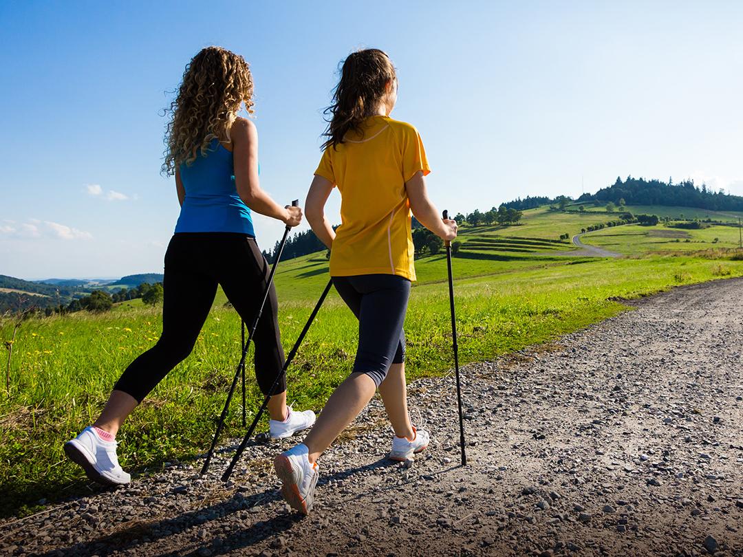 Two women walking up a hill