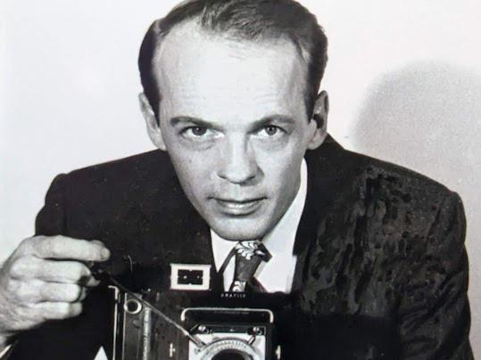 A portrait of Norman B. "Bill" Patterson with his camera