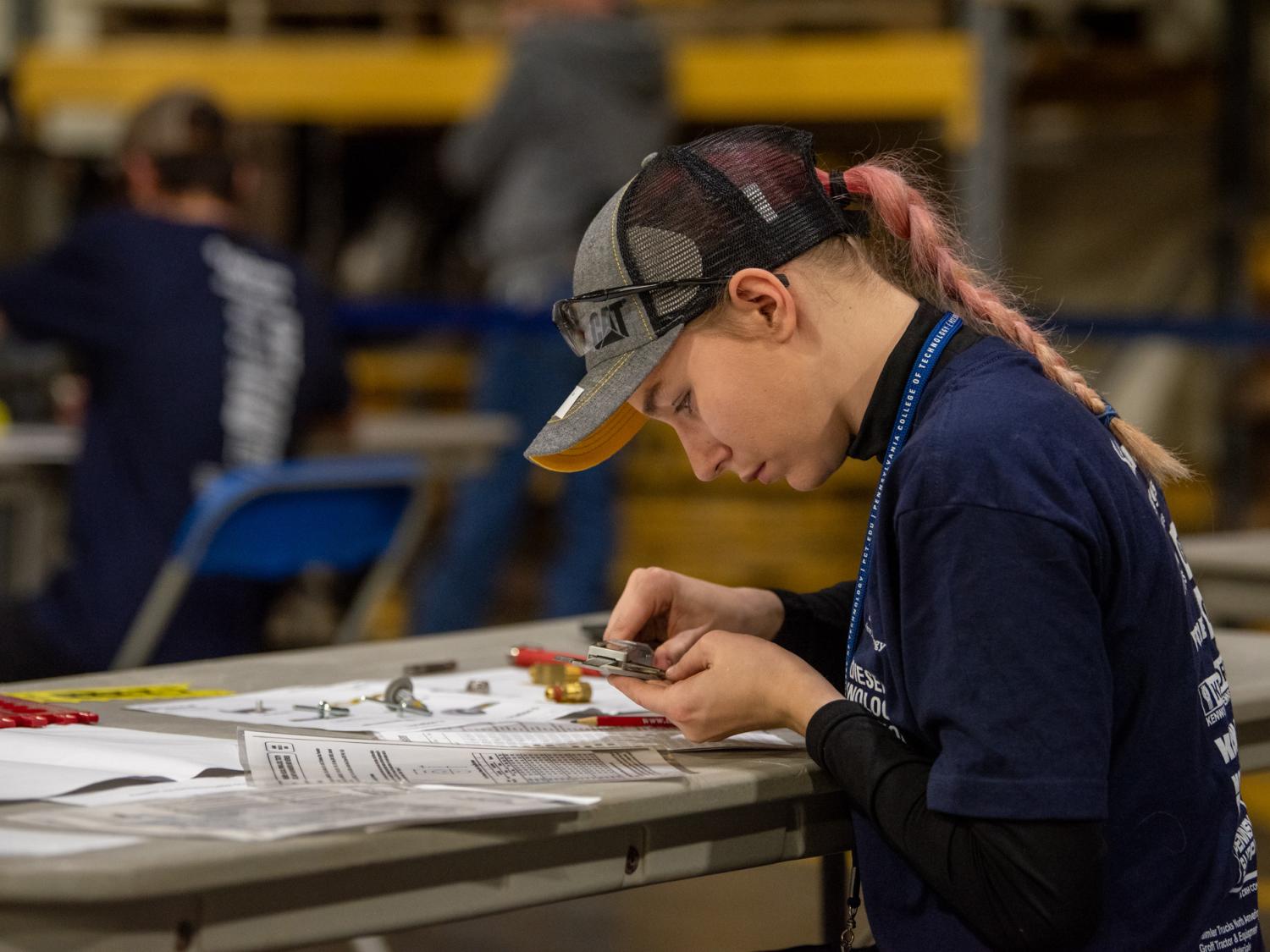A student works on a project at a table for a competition