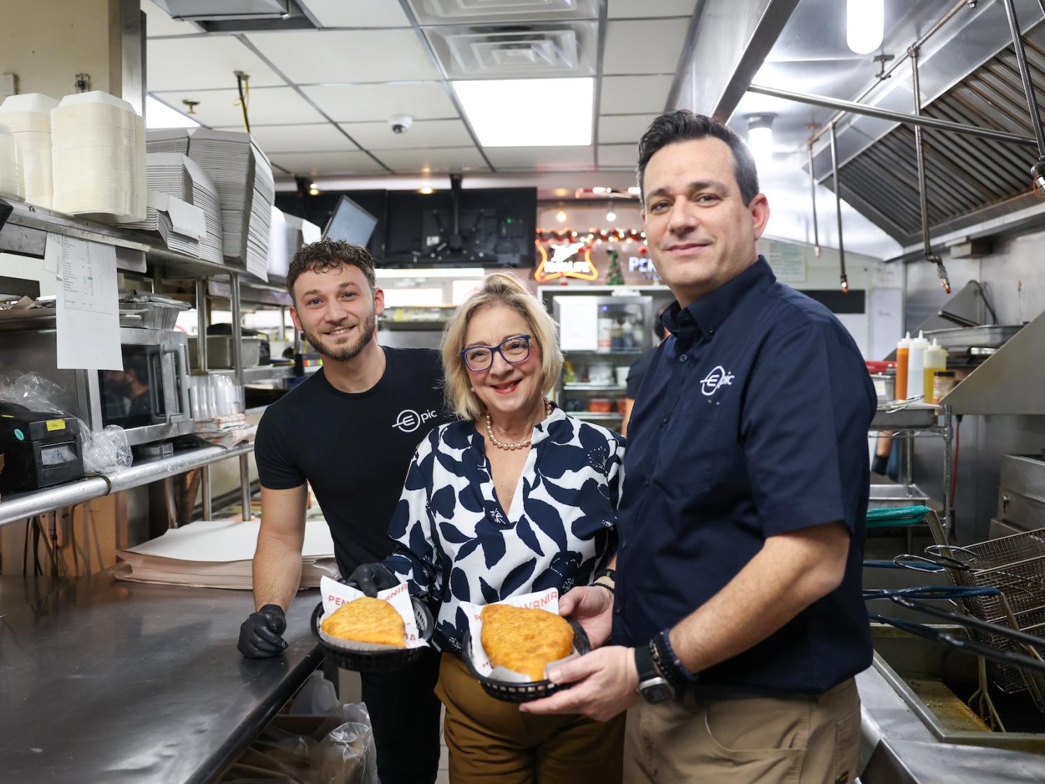 Marilyn and two epic double decker employees holding inside-outs, one of the restaurant's signature dishes