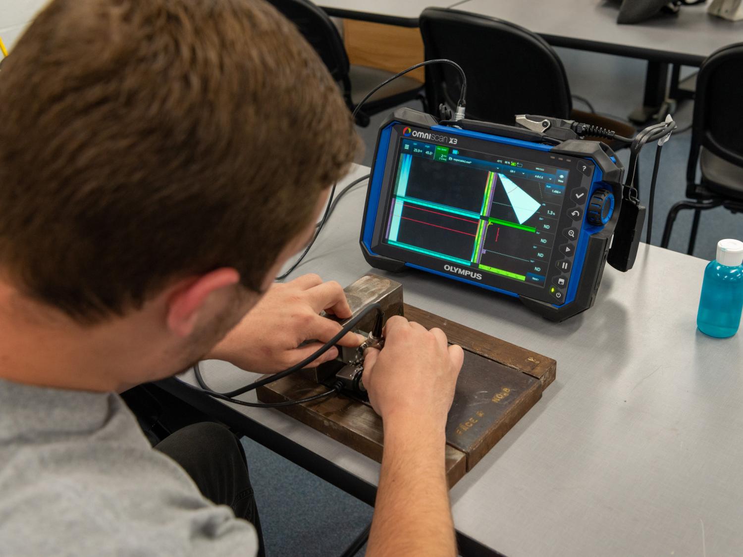 A Pennsylvania College of Technology student engages in non-destructive testing by using the phased-array ultrasonic method. 