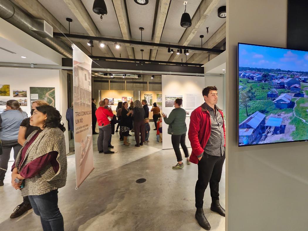 A group of people observe an exhibit at the University of Washington Gould Gallery. 