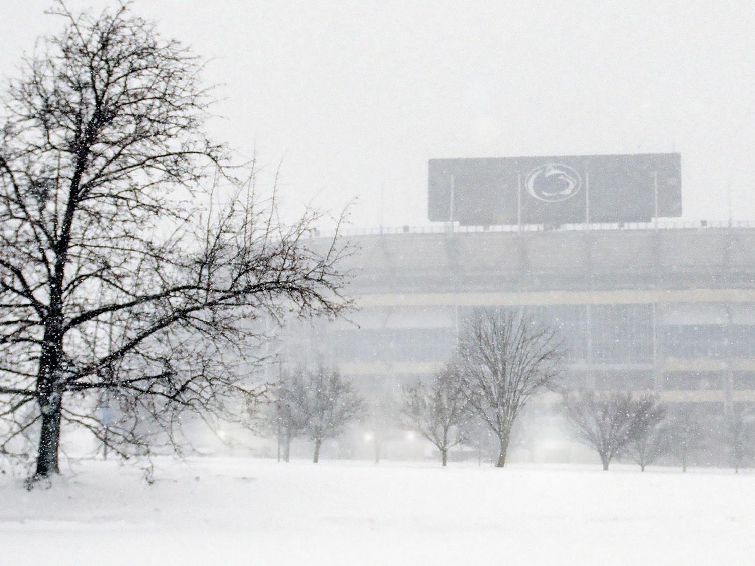 A winter day at University Park, with snow falling and Beaver Stadium in the background