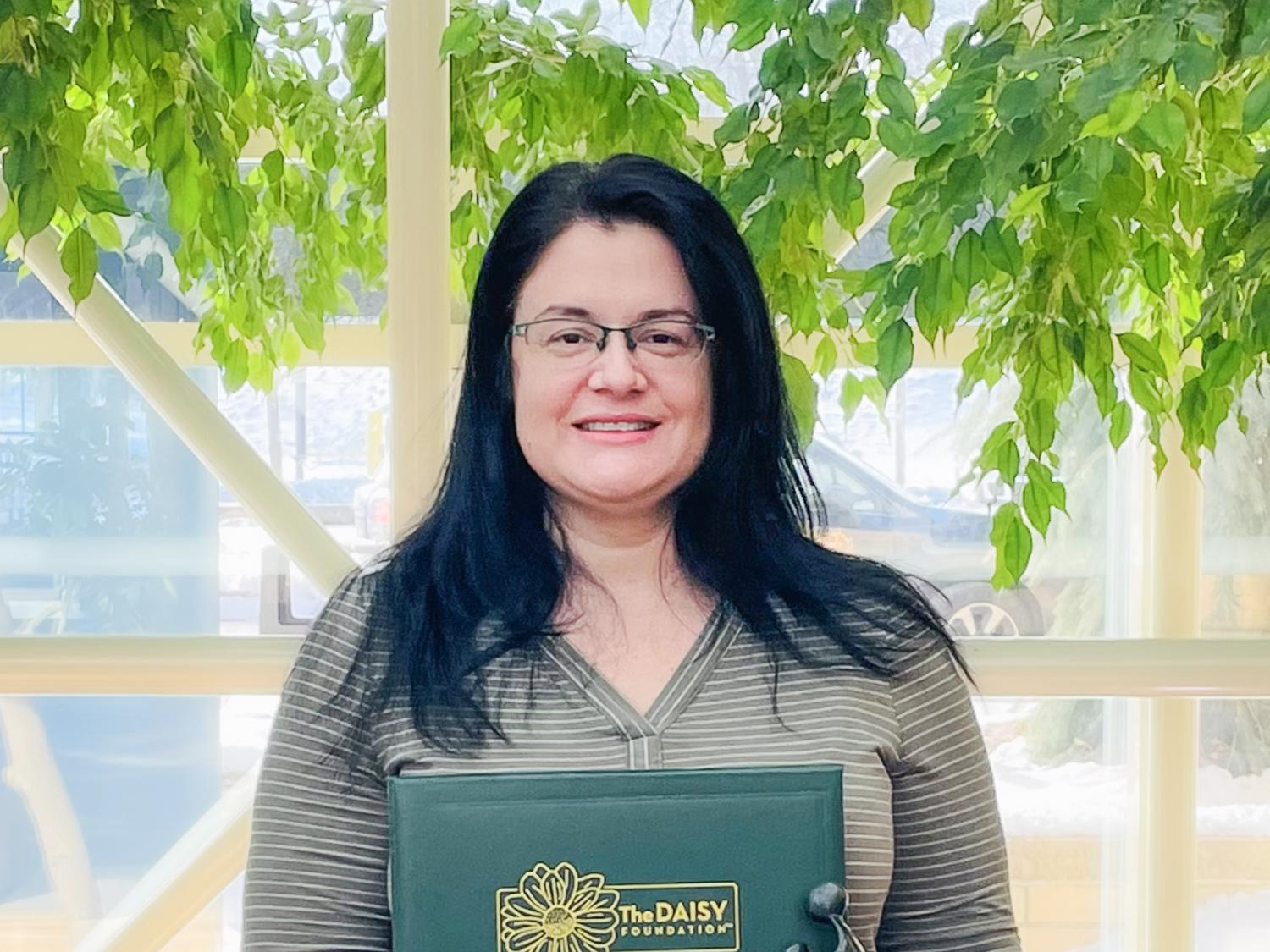 Jennifer Rebmann smiling and holding an award