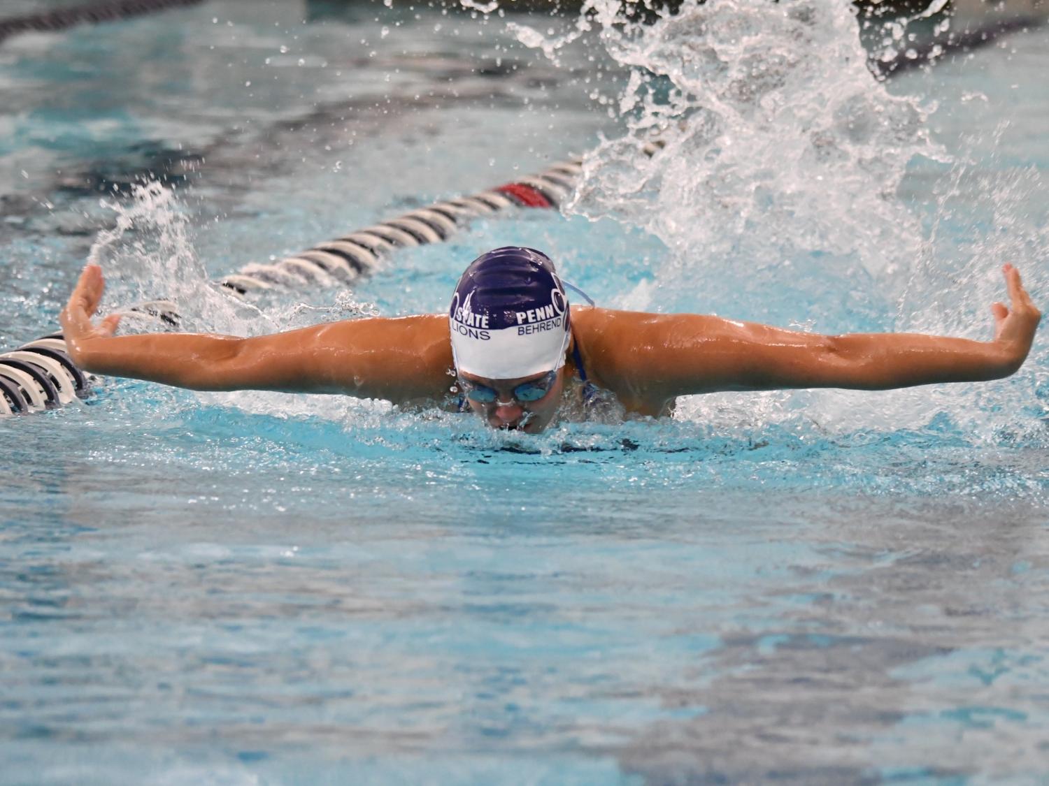 A female swimmer competes in a butterfly event.