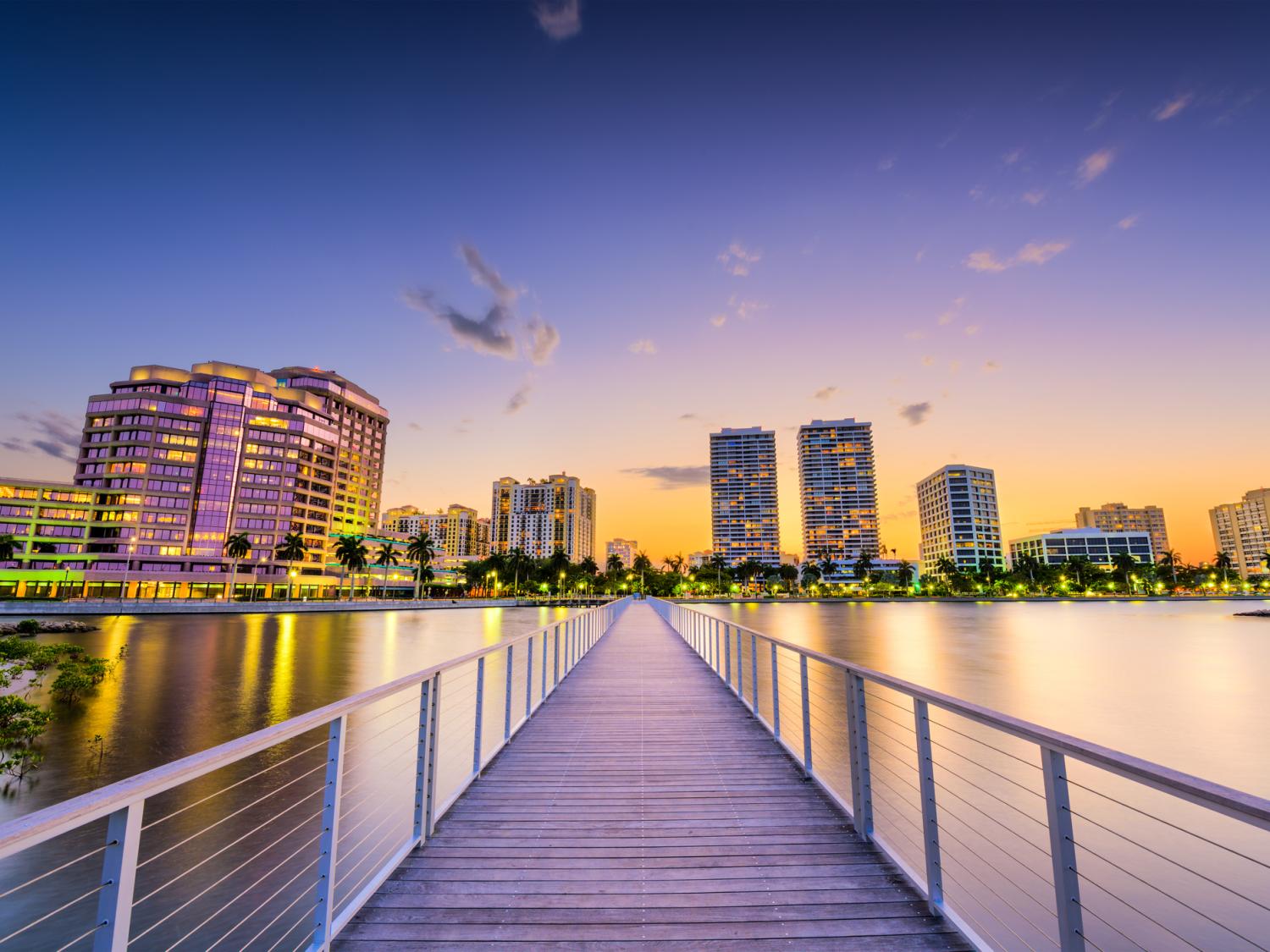 Downtown skyline of West Palm Beach, Florida, pictured at dusk from the intracoastal waterway.
