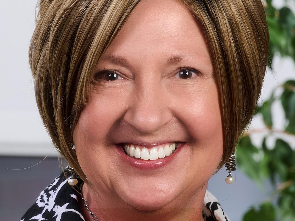 Portrait of Carla Zembal-Saul wearing black-and-white jacket