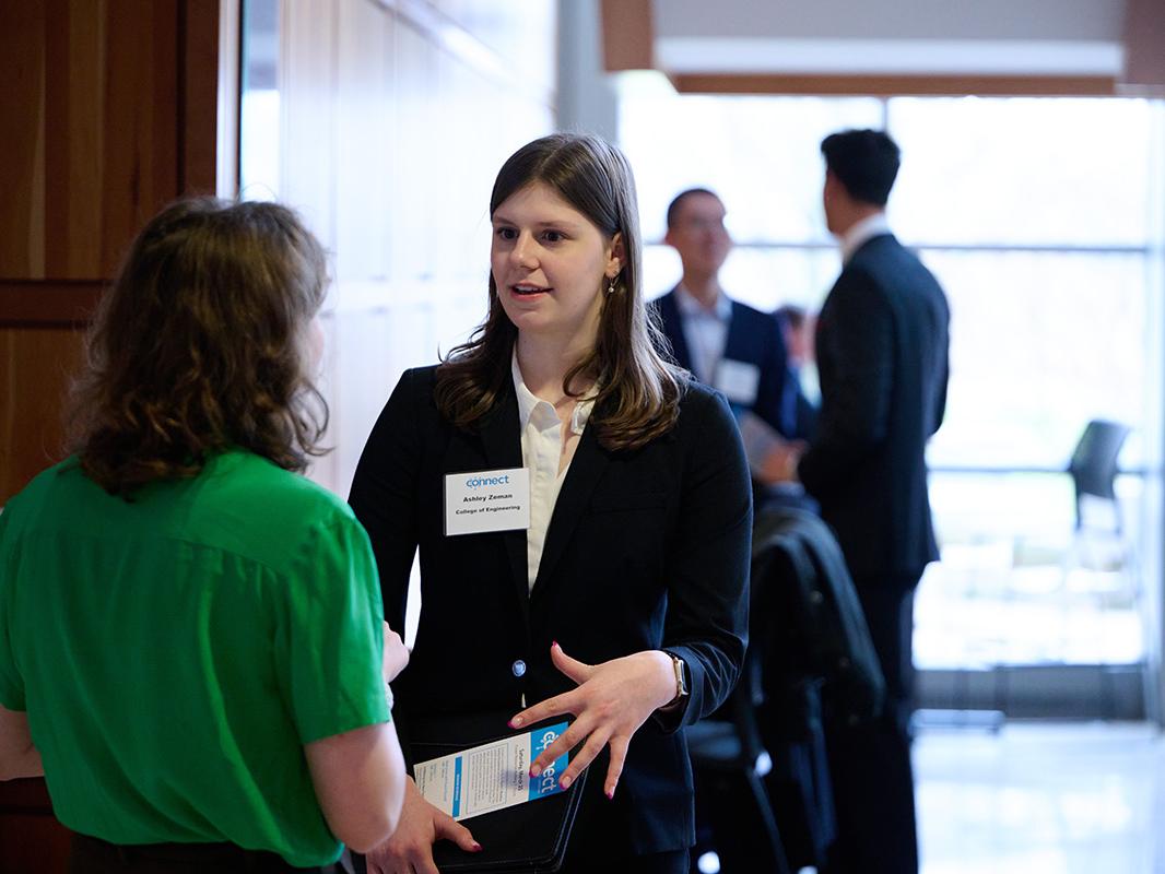 two women talking in a building lobby