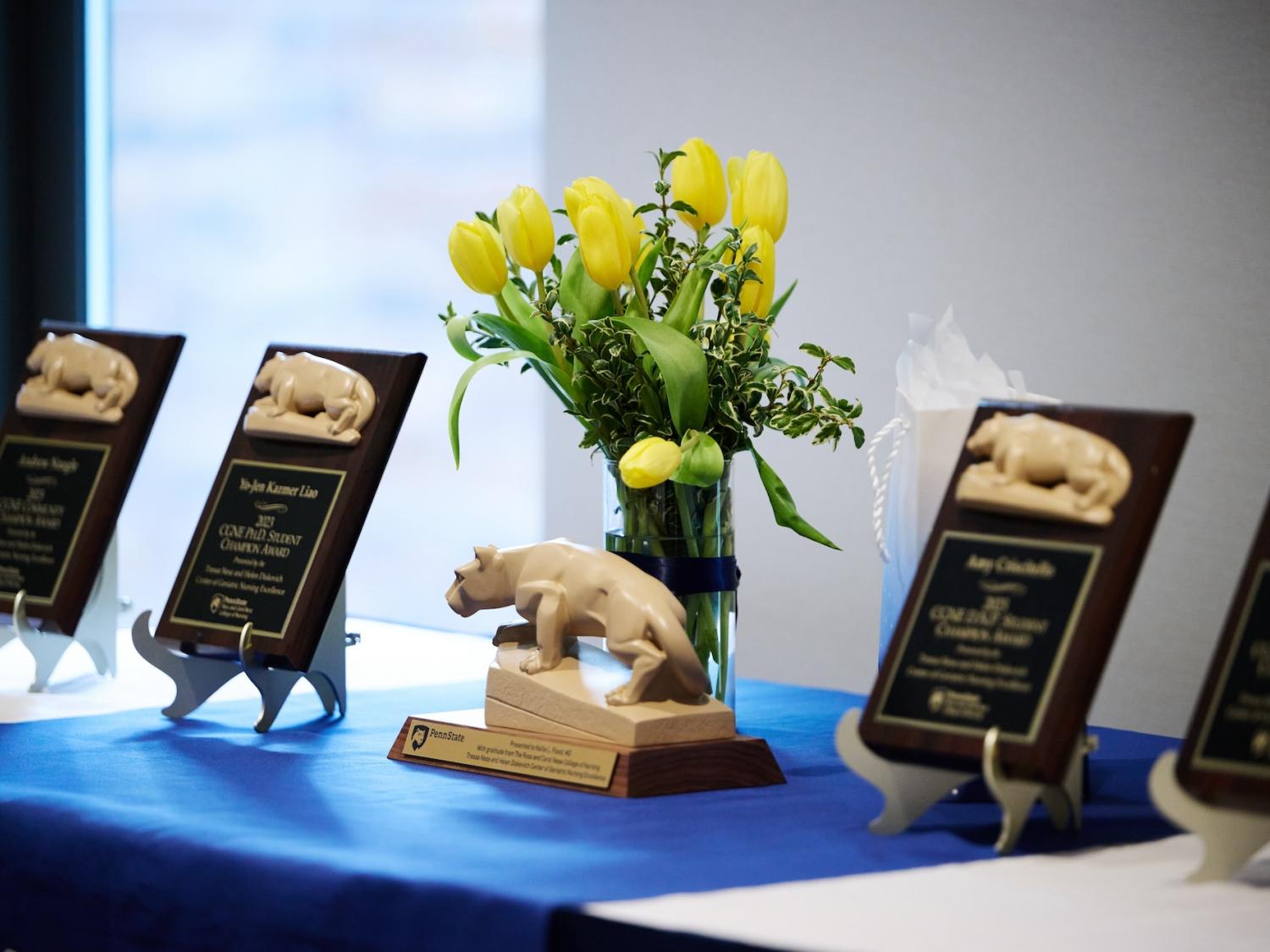 Flowers and awards at the annual CGNE Spring Brunch welcoming table.