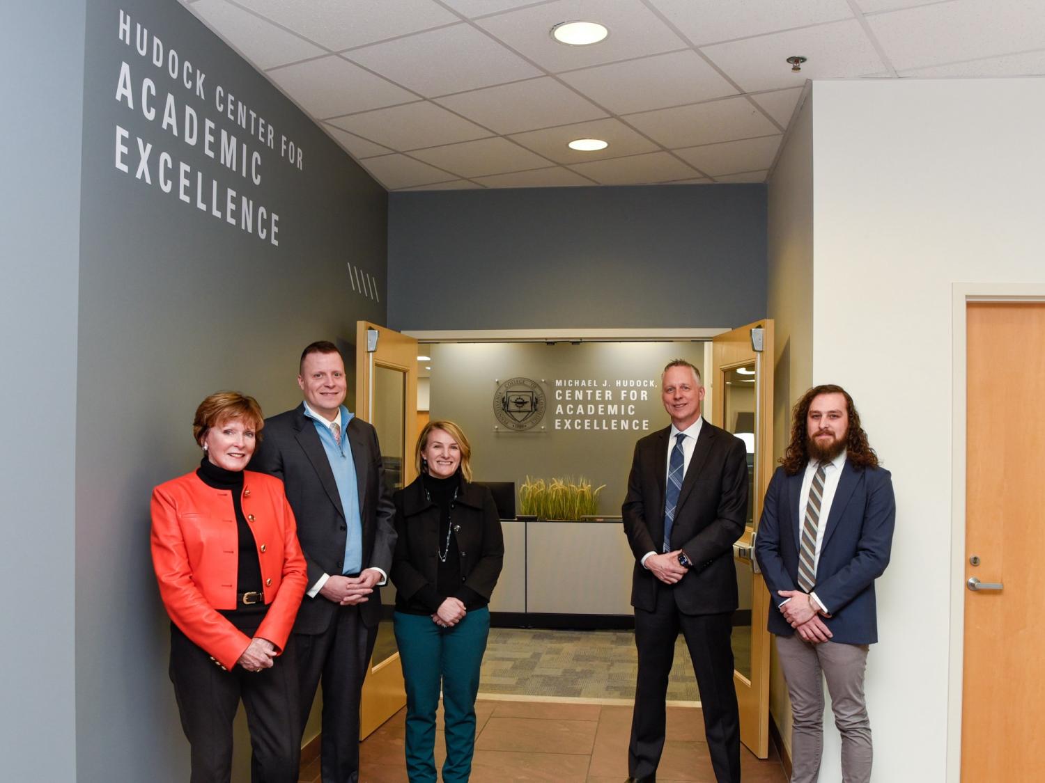 A group of people stand at the entrance to the Michael J. Hudock Sr. Center for Academic Excellence at Pennsylvania College of Technology