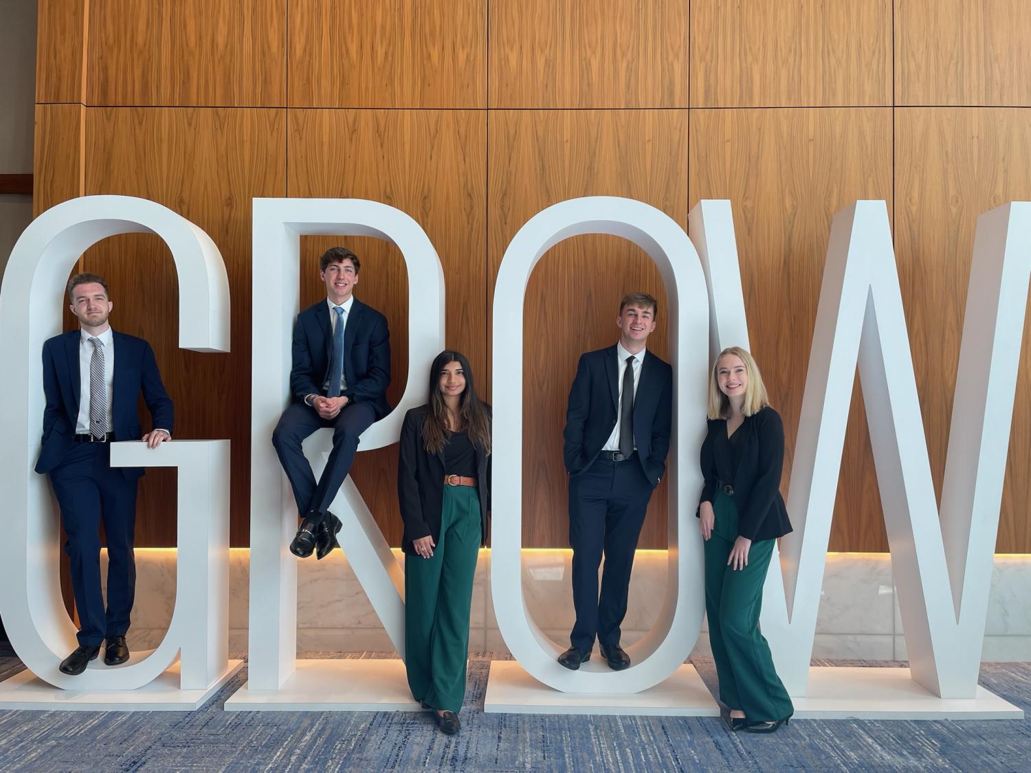 Smeal College of Business students who won the KPMG Ideation Challenge standing in from of GROW sign