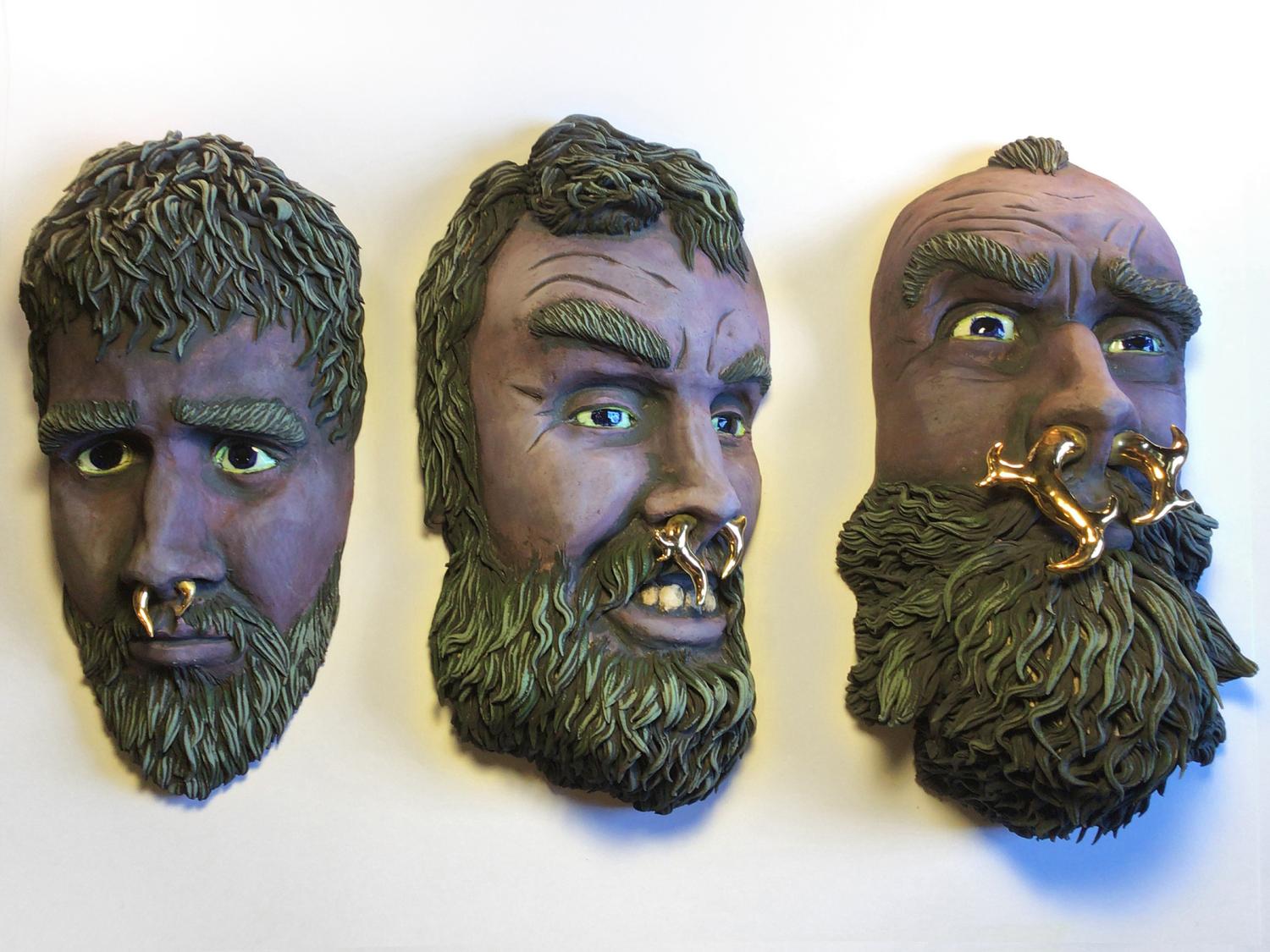 Art that depicts three bearded men's heads