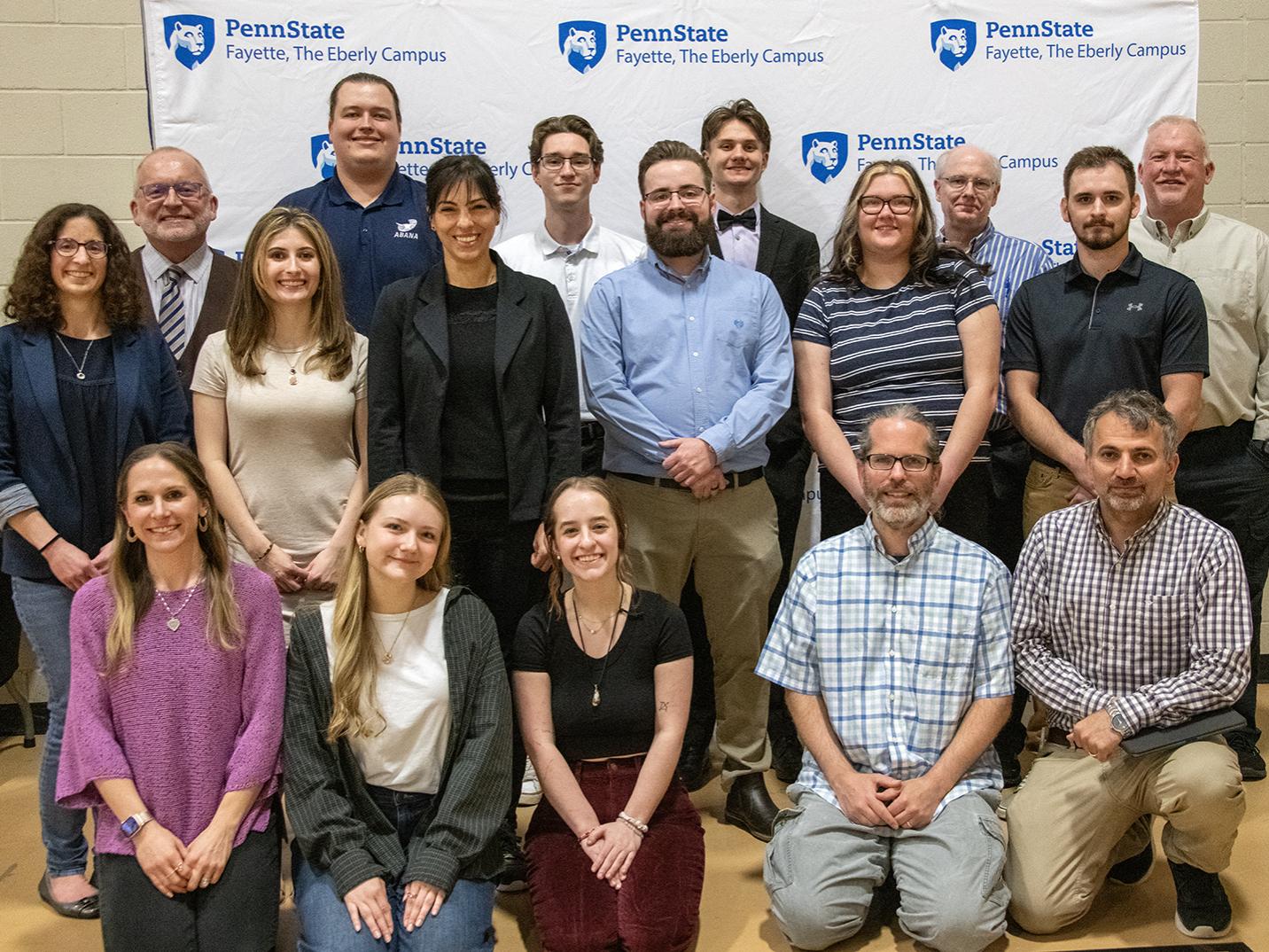Students and faculty mentors posing at the Undergraduate Exhibition.