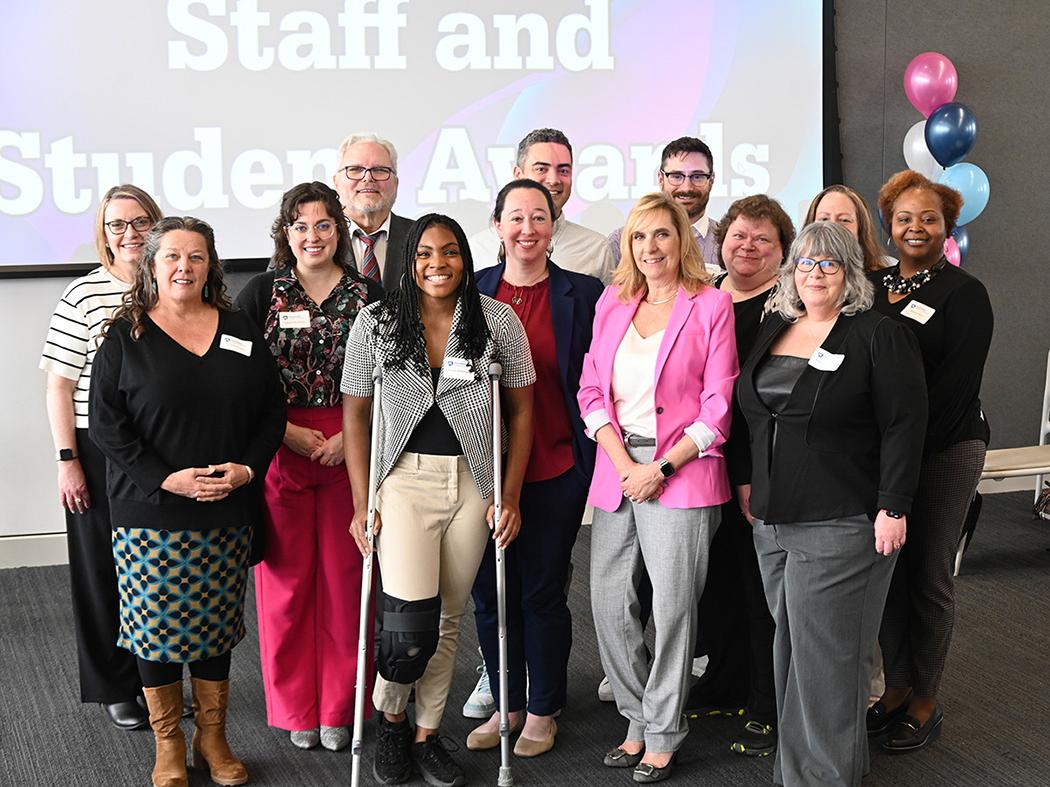 The group of award winners pose for a photo.